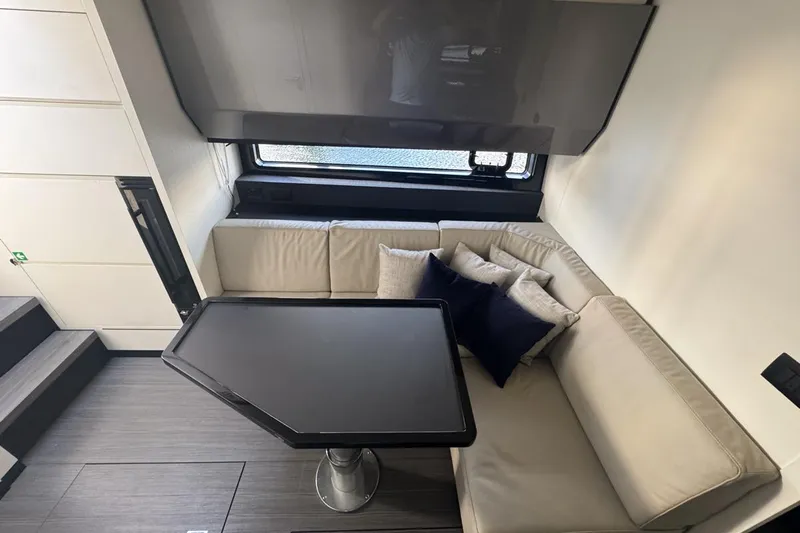 Chicken Money Yacht Photos Pics Luxurious interior of 2023 Azimut Verve 47 yacht with modern seating and table.