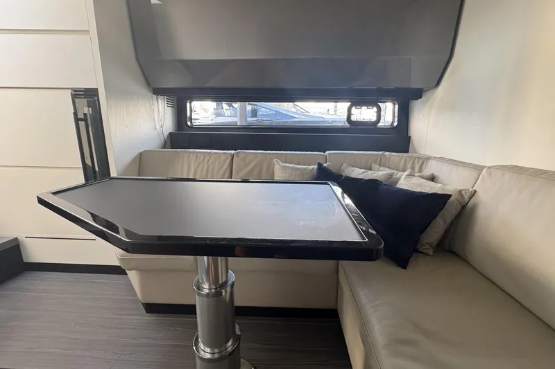 Chicken Money Yacht Photos Pics Interior of 2023 Azimut Verve 47 yacht with sleek table and comfortable seating.