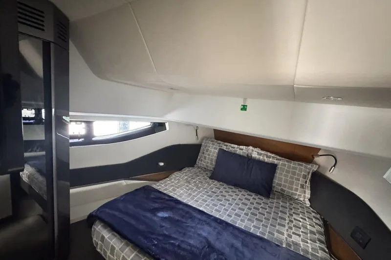 Chicken Money Yacht Photos Pics Luxurious bedroom interior of 2023 Azimut Verve 47 yacht with modern design and cozy bedding.