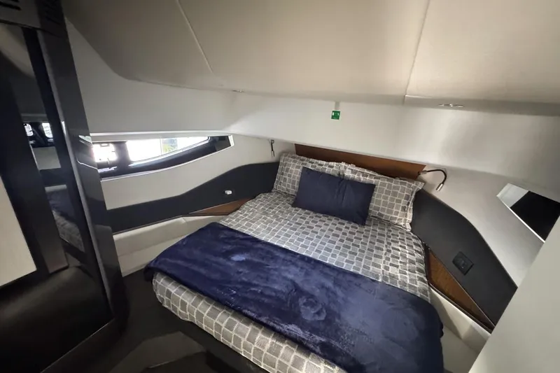 Chicken Money Yacht Photos Pics Luxurious bedroom interior of 2023 Azimut Verve 47 yacht with modern design and cozy bedding.