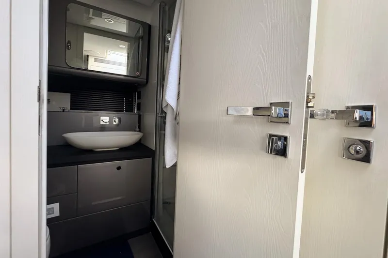 Chicken Money Yacht Photos Pics Modern bathroom interior on 2023 Azimut Verve 47 yacht, featuring sleek design and fixtures.