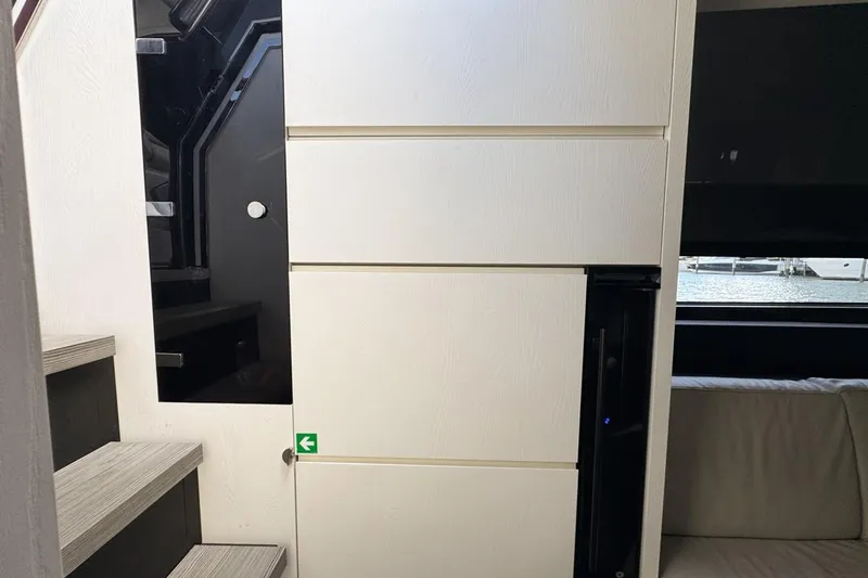 Chicken Money Yacht Photos Pics Interior of 2023 Azimut Verve 47 yacht, featuring modern stairs and sleek cabinetry.