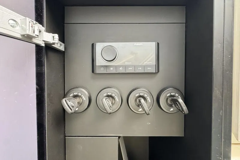 Chicken Money Yacht Photos Pics Control panel of a 2023 Azimut Verve 47 boat with ignition switches and audio system.