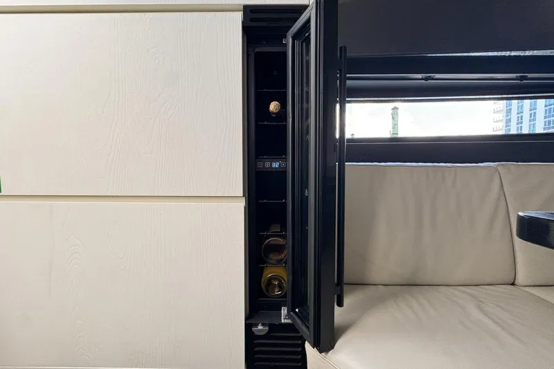 Chicken Money Yacht Photos Pics Luxurious interior of 2023 Azimut Verve 47 yacht with sleek cabinetry and seating.