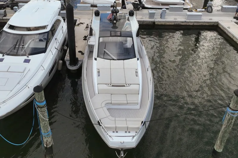 Chicken Money Yacht Photos Pics 2023 Azimut Verve 47 yacht docked at marina, aerial view.