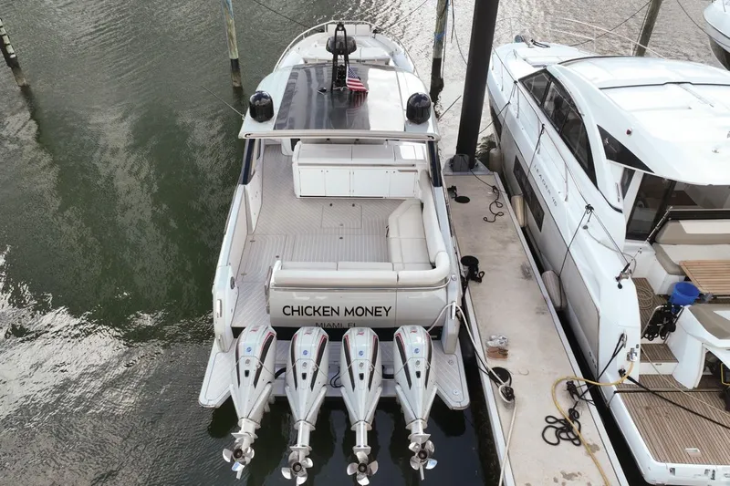Chicken Money Yacht Photos Pics 2023 Azimut Verve 47 yacht docked, rear view with four engines, named "Chicken Money."
