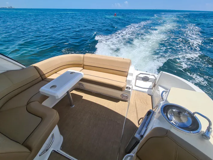  Yacht Photos Pics 2015 Cruisers Yachts 350 Express interior, ocean view, beige seating, and table.
