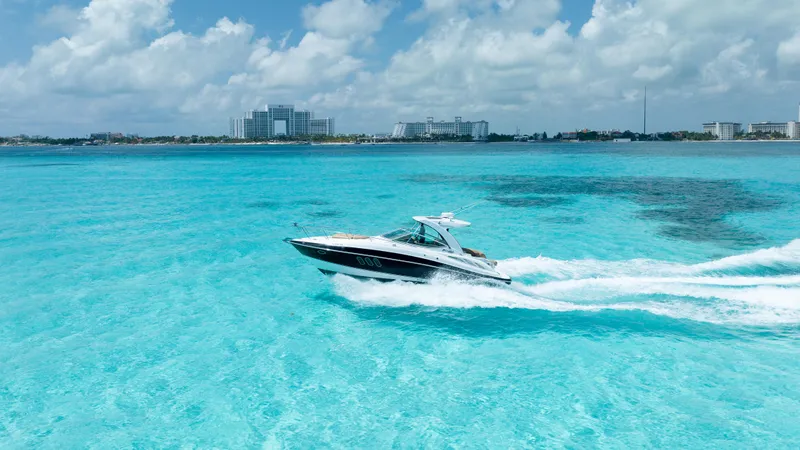  Yacht Photos Pics 2015 Cruisers Yachts 350 Express cruising on clear turquoise waters.