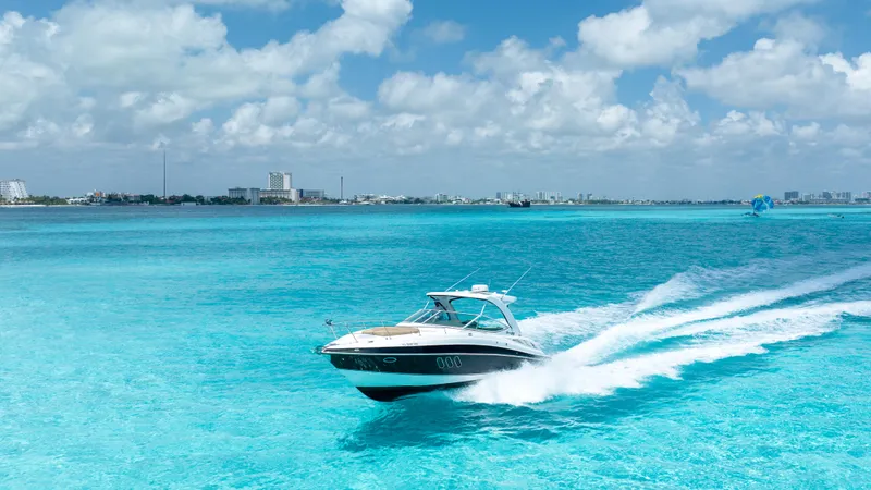  Yacht Photos Pics 2015 Cruisers Yachts 350 Express speeding on turquoise ocean under blue sky.