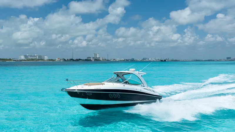  Yacht Photos Pics 2015 Cruisers Yachts 350 Express speeding on turquoise ocean under blue sky.