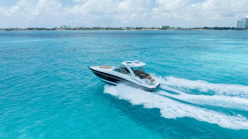  Yacht Photos Pics 2015 Cruisers Yachts 350 Express speeding on clear blue ocean waters.