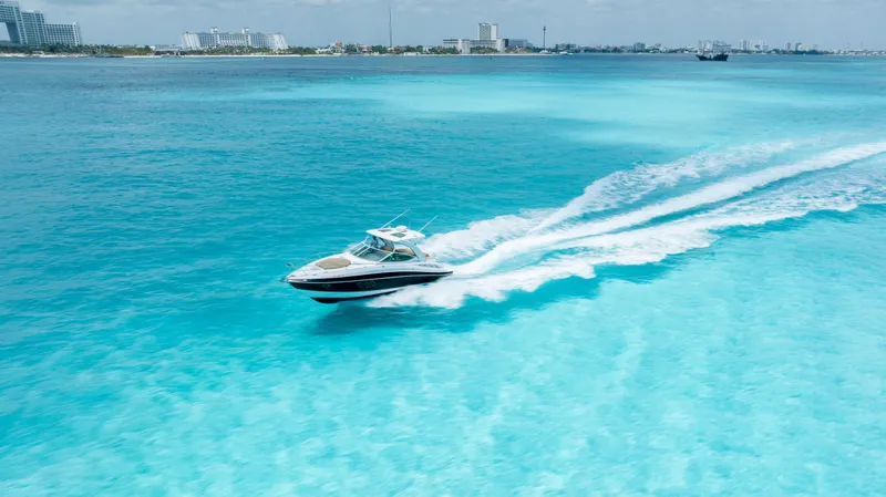  Yacht Photos Pics Cruisers Yachts 350 Express 2015 speeding on turquoise ocean waters.
