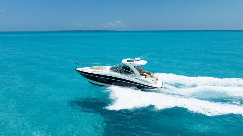  Yacht Photos Pics 2015 Cruisers Yachts 350 Express cruising on clear blue ocean waters.