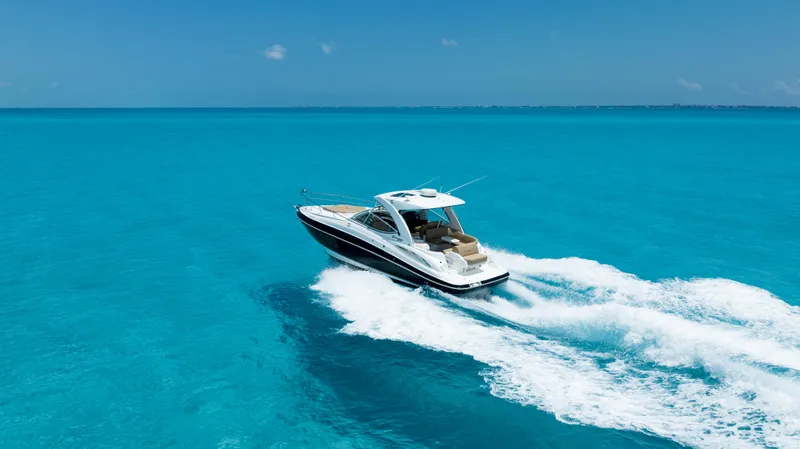  Yacht Photos Pics 2015 Cruisers Yachts 350 Express cruising on clear blue ocean waters.