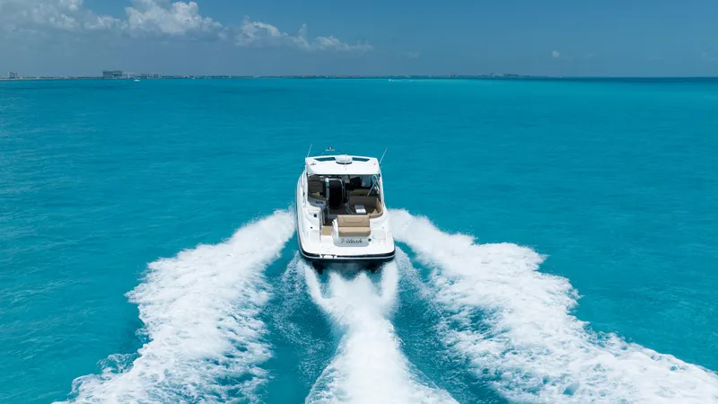  Yacht Photos Pics 2015 Cruisers Yachts 350 Express cruising on vibrant blue ocean waters.