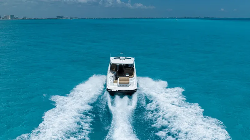  Yacht Photos Pics 2015 Cruisers Yachts 350 Express cruising on clear blue ocean waters.