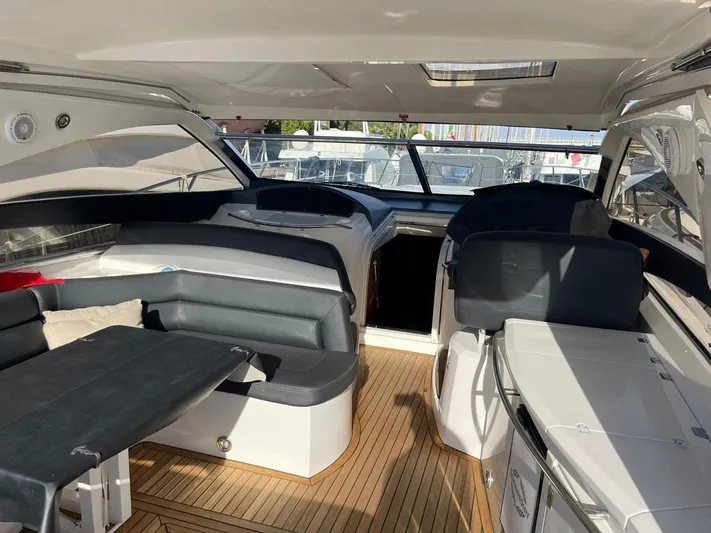  Yacht Photos Pics 2005 Sunseeker Portofino 53 yacht interior with sleek seating and wooden flooring.