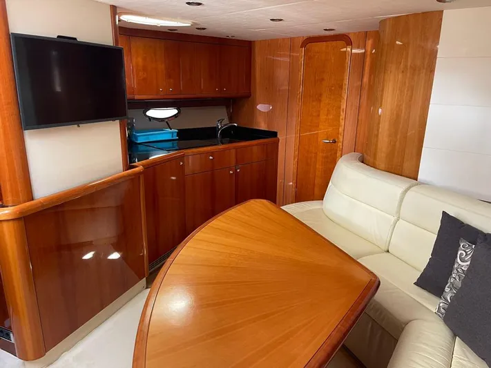  Yacht Photos Pics Luxurious interior of 2005 Sunseeker Portofino 53 yacht with wood finish and leather seating.