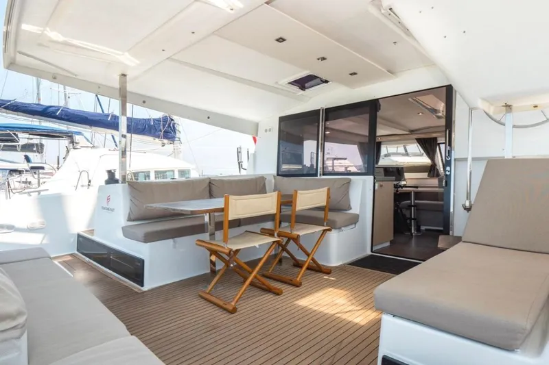 Love Is Yacht Photos Pics Spacious deck of 2019 Fountaine Pajot Lucia 40 Maestro catamaran with seating and table.