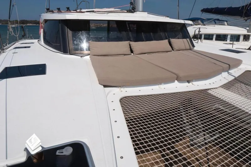 Love Is Yacht Photos Pics 2019 Fountaine Pajot Lucia 40 Maestro catamaran with sunbathing cushions and netting on deck.