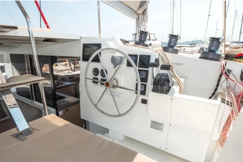 Love Is Yacht Photos Pics Helm station of 2019 Fountaine Pajot LUCIA 40 MAESTRO catamaran, featuring navigation controls.