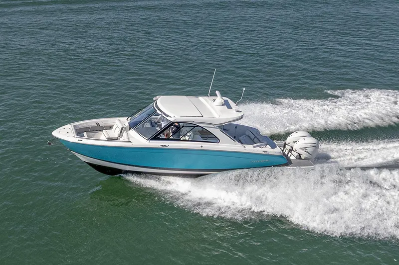 Absolutely Knot Yacht Photos Pics 2022 Regal LX36 boat cruising on open water, showcasing sleek design and powerful engines.