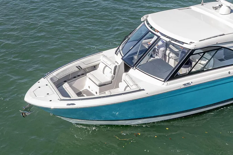 Absolutely Knot Yacht Photos Pics 2022 Regal LX36 boat with sleek design on calm water.