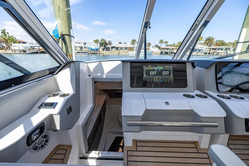 Absolutely Knot Yacht Photos Pics 2022 Regal LX36 boat interior with modern dashboard and scenic waterfront view.