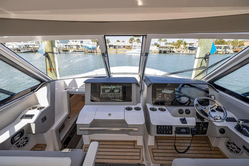 Absolutely Knot Yacht Photos Pics 2022 Regal LX36 boat helm with modern controls and waterfront view.