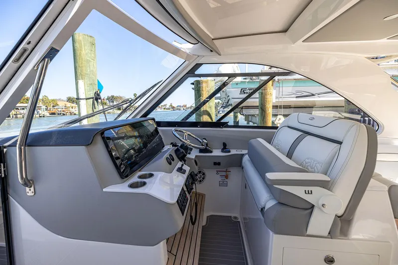 Absolutely Knot Yacht Photos Pics 2022 Regal LX36 boat interior with modern helm and luxurious seating.