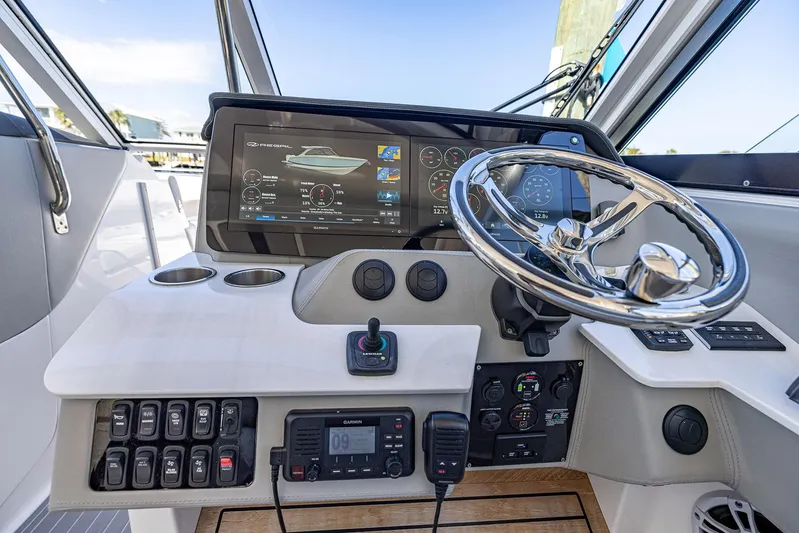 Absolutely Knot Yacht Photos Pics 2022 Regal LX36 boat dashboard with steering wheel and digital display.