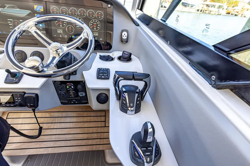 Absolutely Knot Yacht Photos Pics 2022 Regal LX36 boat helm with modern controls and digital displays.
