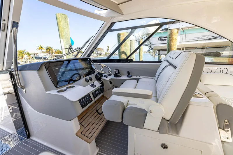 Absolutely Knot Yacht Photos Pics 2022 Regal LX36 boat cockpit with modern controls and luxurious seating.