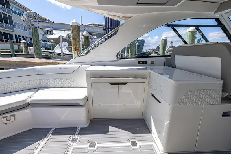 Absolutely Knot Yacht Photos Pics Luxurious interior of 2022 Regal LX36 boat with sleek seating and modern design.