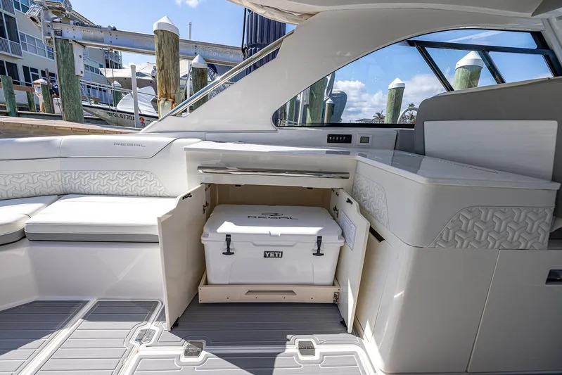 Absolutely Knot Yacht Photos Pics 2022 Regal LX36 boat interior with Yeti cooler, luxurious seating, and modern design.