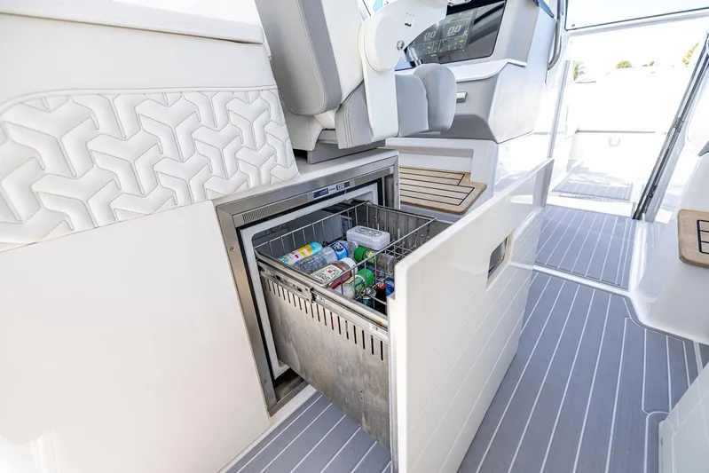 Absolutely Knot Yacht Photos Pics 2022 Regal LX36 boat interior with open fridge, stocked with drinks and snacks.