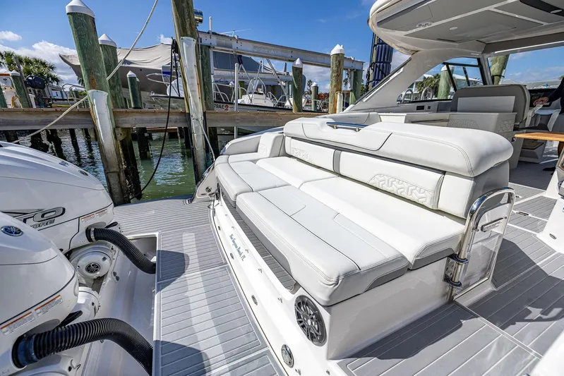 Absolutely Knot Yacht Photos Pics 2022 Regal LX36 luxury boat with white seating, docked at marina.