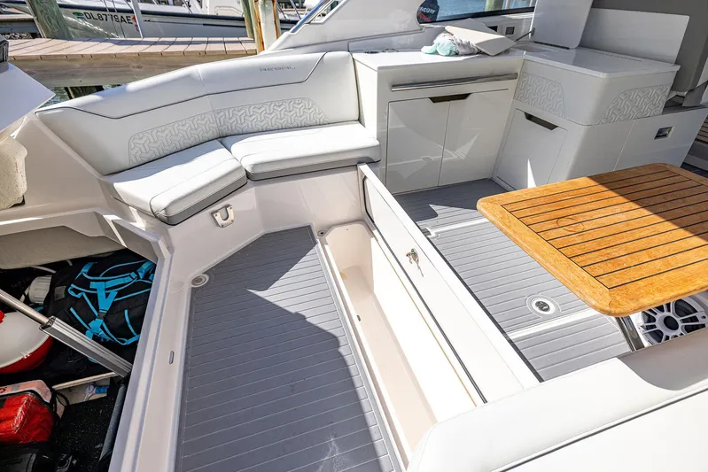 Absolutely Knot Yacht Photos Pics Luxurious 2022 Regal LX36 boat interior with seating and wooden table.