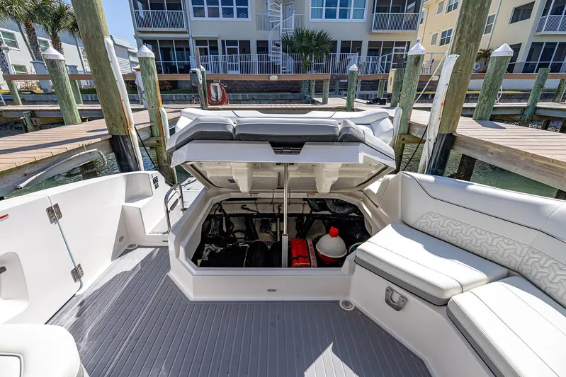 Absolutely Knot Yacht Photos Pics 2022 Regal LX36 boat interior with open storage compartment at dockside.