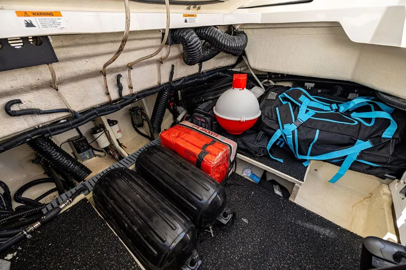 Absolutely Knot Yacht Photos Pics 2022 Regal LX36 boat storage area with equipment and safety gear.