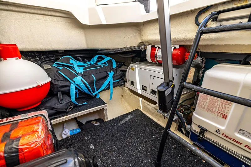Absolutely Knot Yacht Photos Pics 2022 Regal LX36 boat storage area with equipment, bags, and safety gear.