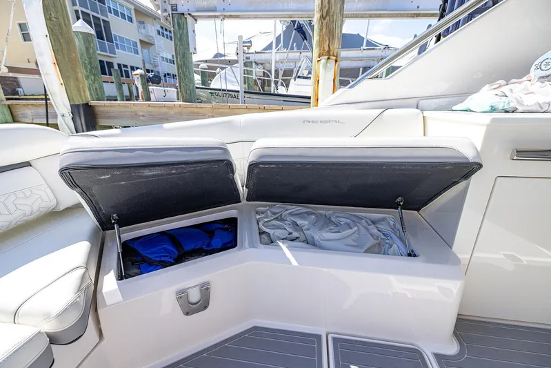Absolutely Knot Yacht Photos Pics 2022 Regal LX36 boat with open storage compartments, docked at marina.