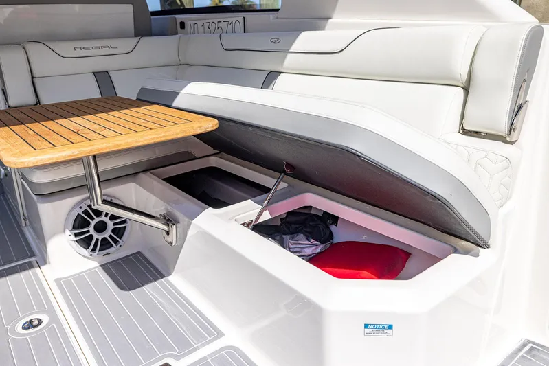 Absolutely Knot Yacht Photos Pics 2022 Regal LX36 boat interior with storage compartment and wooden table.