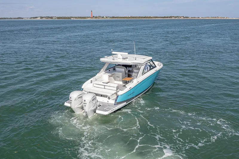 Absolutely Knot Yacht Photos Pics 2022 Regal LX36 boat cruising on open water with twin Yamaha engines.