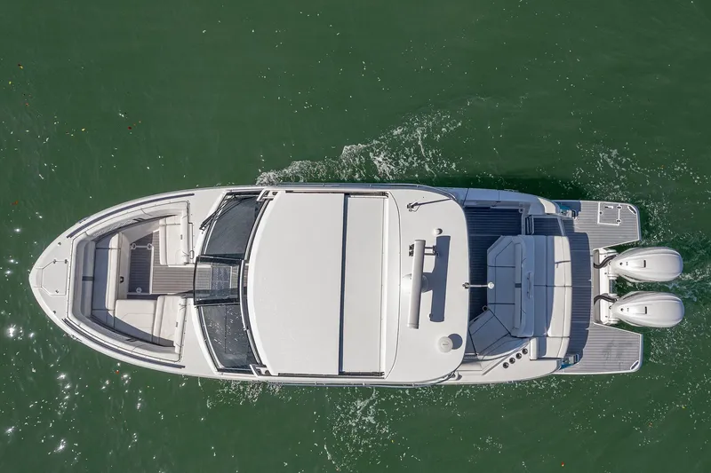 Absolutely Knot Yacht Photos Pics Overhead view of 2022 Regal LX36 boat cruising on water.