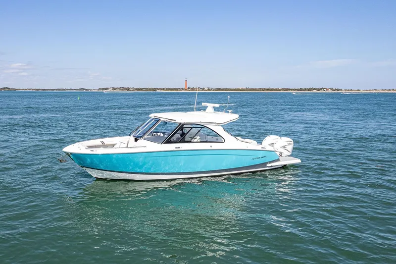 Absolutely Knot Yacht Photos Pics 2022 Regal LX36 boat on open water, clear sky, distant shoreline.