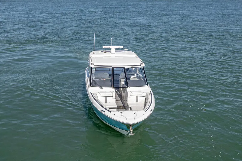 Absolutely Knot Yacht Photos Pics 2022 Regal LX36 boat on open water, front view.