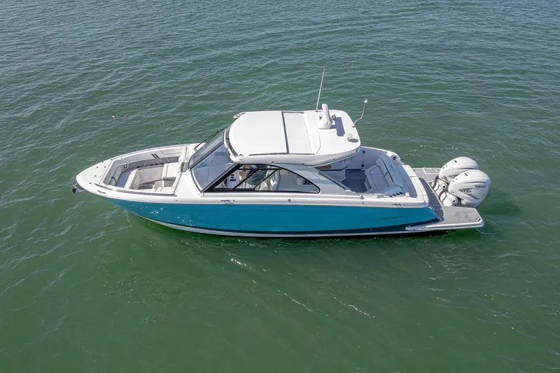 Absolutely Knot Yacht Photos Pics 2022 Regal LX36 boat on water, featuring sleek design and dual outboard engines.