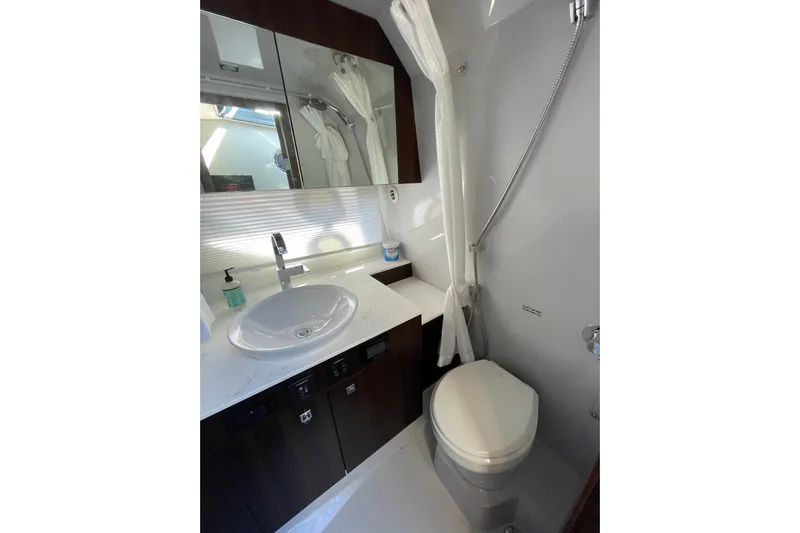  Yacht Photos Pics 2023 Cruisers Yachts 38 GLS I/O bathroom with sink, mirror, and toilet.