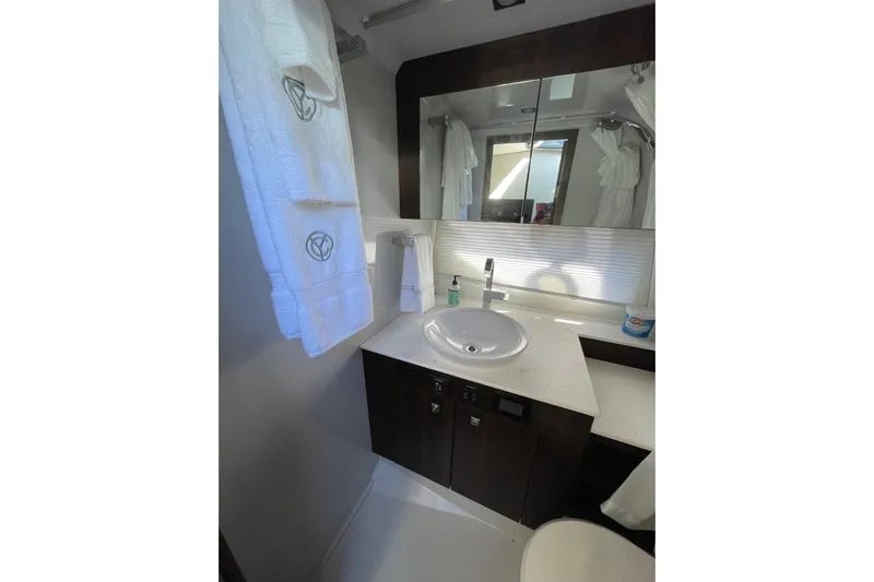  Yacht Photos Pics Modern bathroom in 2023 Cruisers Yachts 38 GLS I/O with sleek sink and mirror.
